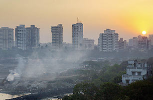 Smoke rises from burning garbage, adding to a blanket of smog already hovering over Mumbai Rob Elliott / AFP / Getty