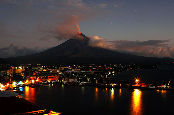 Mayon Volcano spews lava at dawn